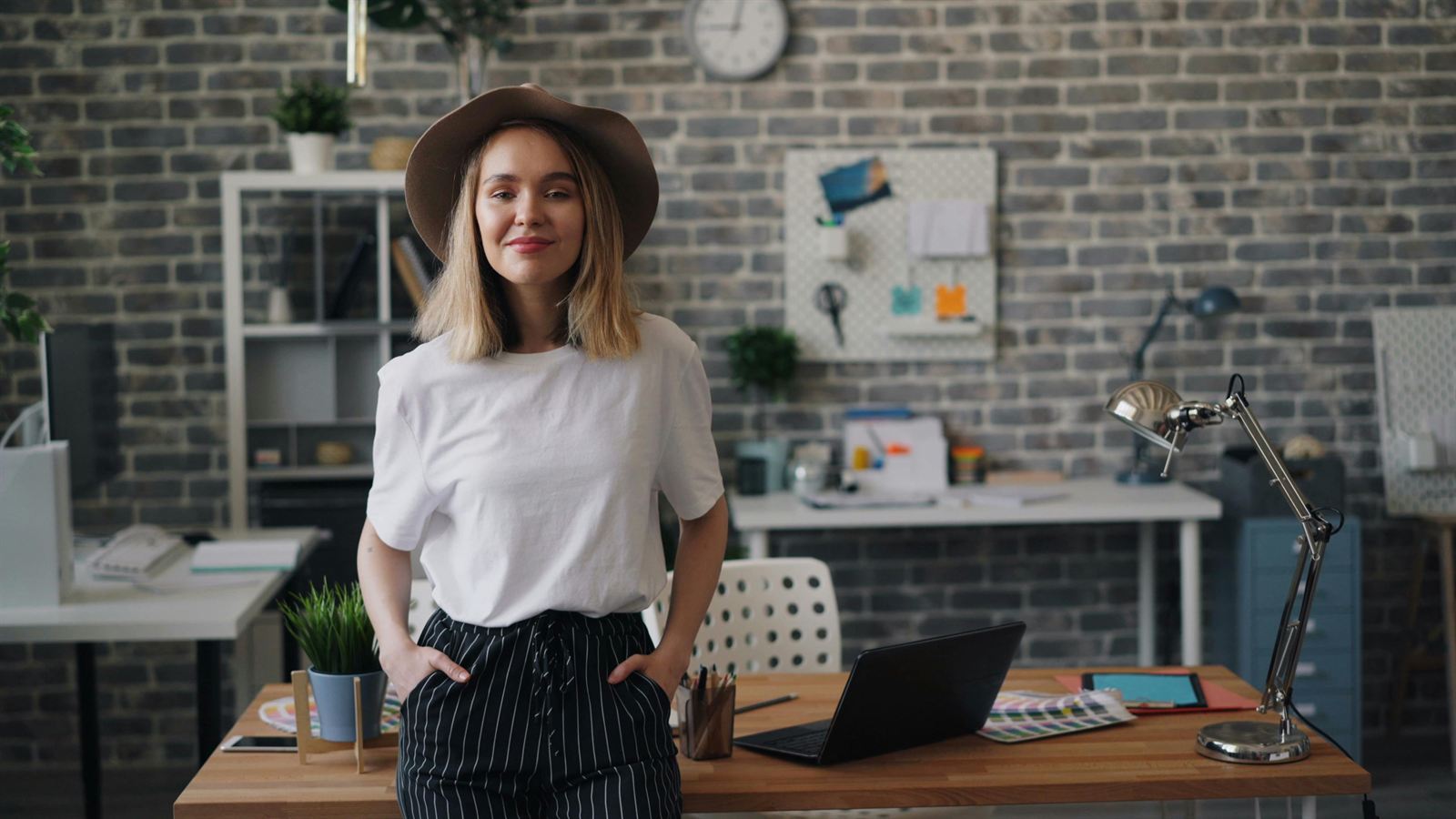 A confident professional standing in a creative workspace