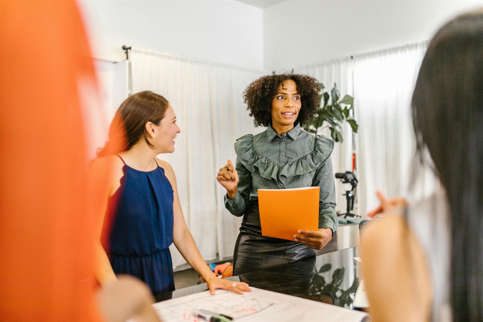 A leader directing and engaging her team in a meeting