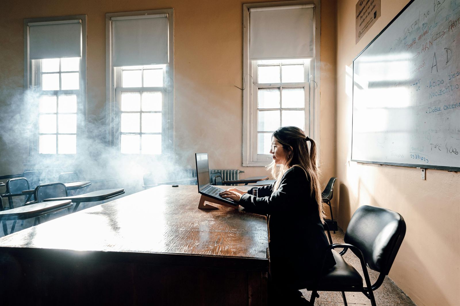 A student working on a laptop in a classroom