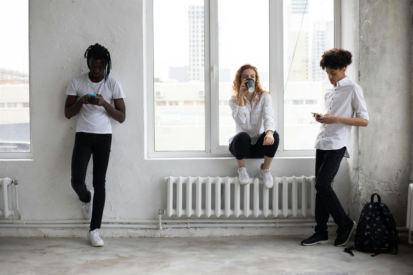 People around a table looking at their phones instead of each other