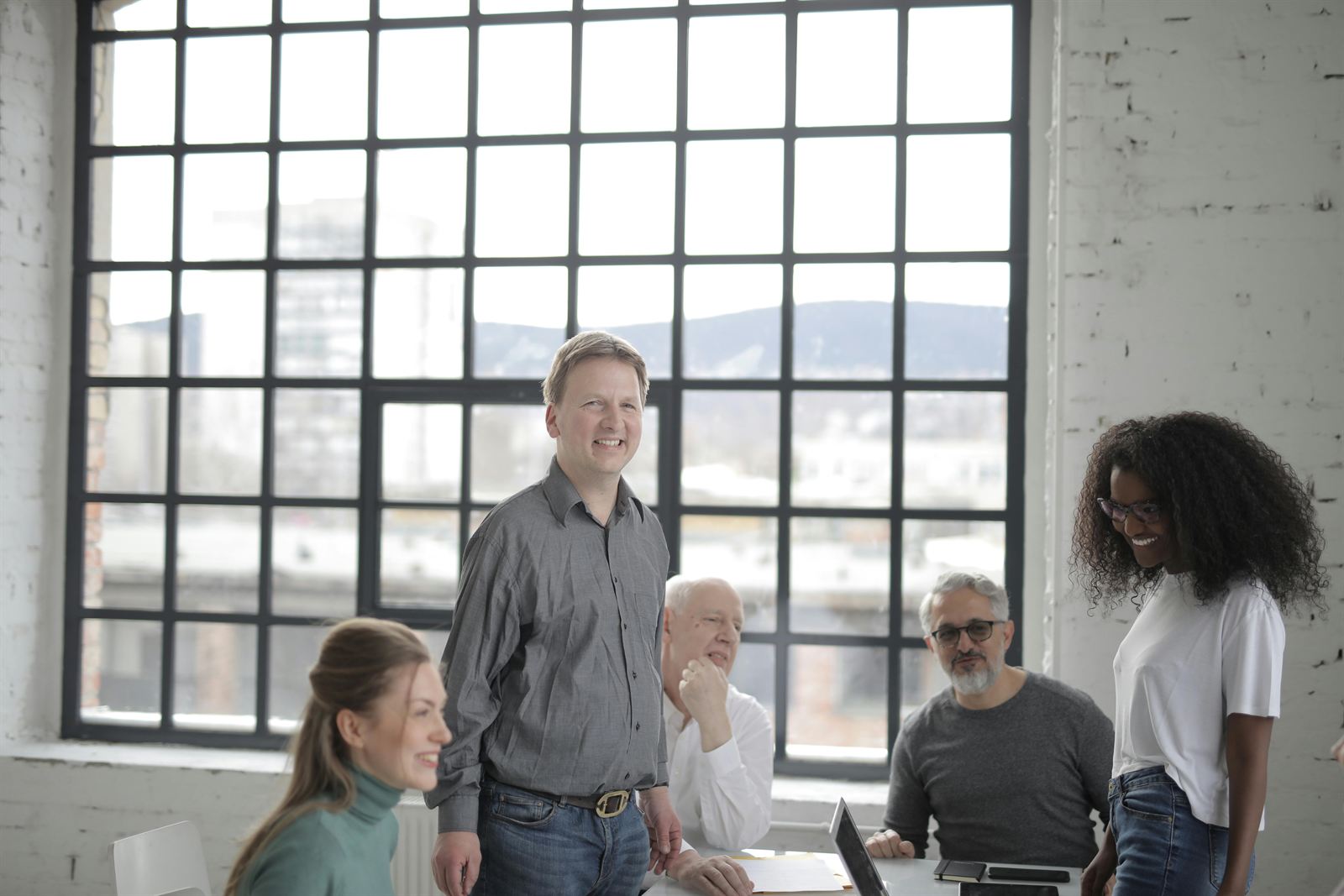 A relaxed, diverse team working together in an open studio