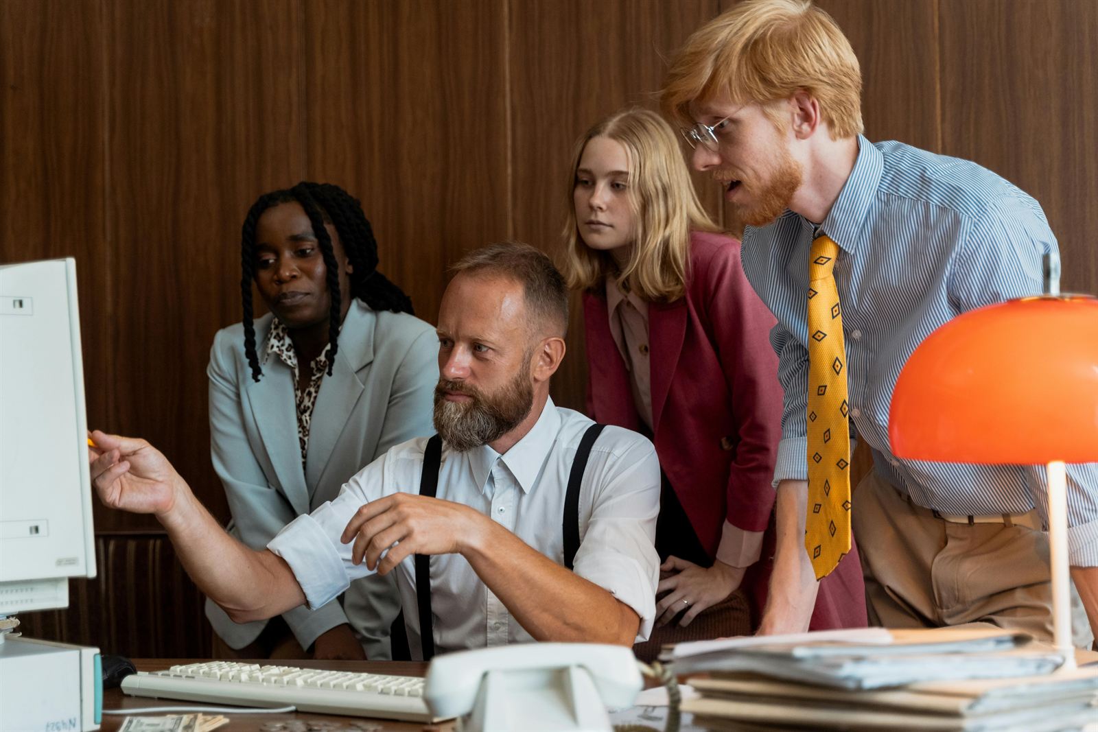 A manager and team reviewing a screen together