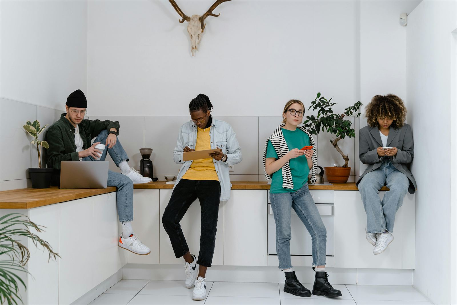 A diverse group of young professionals working in a bright open space